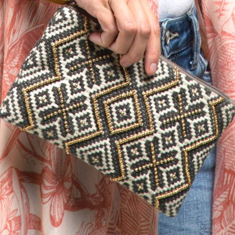 woman with red flower clutch